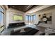 Luxurious main bedroom featuring a fireplace, marble accent wall, and expansive views at 4 Olympia Summit Dr, Las Vegas, NV 89141