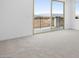 Bright bedroom with balcony access, plush carpet, and neutral paint at 651 N Water St, Henderson, NV 89015