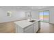 Bright, open-concept kitchen with stainless appliances, an island, and wood floors at 651 N Water St, Henderson, NV 89015