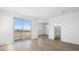 Spacious living room features wood-look flooring, a balcony, and entrances to other rooms at 651 N Water St, Henderson, NV 89015