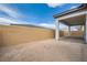 The backyard has a covered patio and a block wall that provides privacy at 853 Bittern Lake St, Henderson, NV 89011