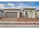 Charming single-story home with a brick driveway and well-maintained landscaping at 853 Bittern Lake St, Henderson, NV 89011