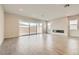 Bright living room featuring gray floors, large windows, and a sleek fireplace at 853 Bittern Lake St, Henderson, NV 89011