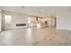 Open-concept living area with wood-look tile floors, fireplace, and bright kitchen in the background at 853 Bittern Lake St, Henderson, NV 89011