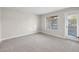 Bright bedroom with carpet and access to patio at 2130 Sealion Dr # 207, Las Vegas, NV 89128