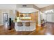 Modern kitchen with breakfast bar, stainless steel appliances, and adjacent dining area, all with wood flooring at 222 Karen Ave # 3307, Las Vegas, NV 89109
