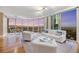 Open living space with floor-to-ceiling windows providing views of the city, wood floors, and contemporary decor at 222 Karen Ave # 3307, Las Vegas, NV 89109