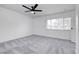 Light and airy bedroom featuring grey carpet and a ceiling fan at 3511 Blackstone St, Las Vegas, NV 89121