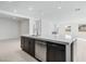 Spacious kitchen island with stainless steel dishwasher and dark brown cabinets at 1005 Warsaw Ave, Henderson, NV 89015