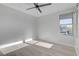Bright bedroom with wood-look floors, ceiling fan, and large window at 10254 Fairview Ridge Ct, Las Vegas, NV 89166