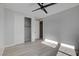 Bedroom with wood-look floors, ceiling fan, and sliding closet doors at 10254 Fairview Ridge Ct, Las Vegas, NV 89166
