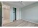 Light blue bedroom with wood-look floors, a closet, and access to another room at 10254 Fairview Ridge Ct, Las Vegas, NV 89166