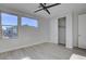 Bedroom featuring wood-look floors, large windows, and a spacious closet at 10254 Fairview Ridge Ct, Las Vegas, NV 89166