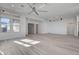 Open living area with hardwood floors and multiple ceiling fans at 10254 Fairview Ridge Ct, Las Vegas, NV 89166