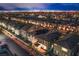 Night aerial view of rooftops with city lights in the distance at 8021 Adelaide Hills St, Las Vegas, NV 89113