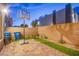 Backyard features a basketball hoop, brick border, and artificial turf at 8021 Adelaide Hills St, Las Vegas, NV 89113