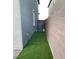 Side yard features artificial turf between the wall and side of the home at 8021 Adelaide Hills St, Las Vegas, NV 89113