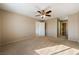 Spacious bedroom with ceiling fan and carpet at 2360 Greyhound St, Pahrump, NV 89060