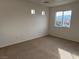 Bright bedroom with neutral carpet, multiple windows and views of the surrounding neighborhood at 9092 Iron Cactus Ave, Las Vegas, NV 89148