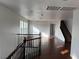 Bright living room with hardwood floors, staircase, chandelier, and natural light from multiple windows at 9092 Iron Cactus Ave, Las Vegas, NV 89148