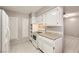 Galley kitchen with white cabinets and appliances at 3187 Silver Saddle St, Las Vegas, NV 89169