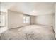 Bright living room featuring large windows and grey carpet at 3187 Silver Saddle St, Las Vegas, NV 89169