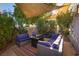 Relaxing backyard patio with seating area and shade sails at 3368 Epson St, Las Vegas, NV 89129