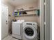 Laundry room with washer, dryer, and ample shelving at 3368 Epson St, Las Vegas, NV 89129