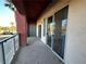 Relaxing balcony featuring glass railings and sliding glass doors with a view at 71 E Agate Ave # 207, Las Vegas, NV 89123