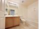 Bathroom featuring a wooden vanity, neutral tiling, toilet, and bathtub/shower combo at 71 E Agate Ave # 207, Las Vegas, NV 89123