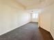 Unfurnished room offering neutral walls, carpet flooring, and a bright window at 71 E Agate Ave # 207, Las Vegas, NV 89123