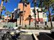 Multi-story condominium exterior with palm trees and street parking at 71 E Agate Ave # 207, Las Vegas, NV 89123