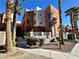 Exterior view of building with palm trees, gated fence, and landscape at 71 E Agate Ave # 207, Las Vegas, NV 89123