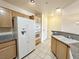 Bright kitchen featuring neutral toned cabinets, granite counters, and tile flooring at 71 E Agate Ave # 207, Las Vegas, NV 89123