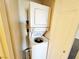 Efficient laundry area featuring a stacked washer and dryer, maximizing space at 71 E Agate Ave # 207, Las Vegas, NV 89123