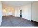 Open living room area featuring plush gray carpeting and neutral walls at 71 E Agate Ave # 207, Las Vegas, NV 89123