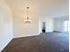 The living room features an elegant chandelier and an open floorplan at 71 E Agate Ave # 207, Las Vegas, NV 89123