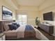 Main bedroom with a large bed, TV, and sliding doors to a balcony at 71 E Agate Ave # 207, Las Vegas, NV 89123