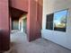 Comfortable outdoor patio area with sliding glass doors and stucco walls at 71 E Agate Ave # 207, Las Vegas, NV 89123