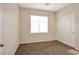 Simple bedroom with window, blinds, and double doors at 8152 Satin Carnation Ln, Las Vegas, NV 89166