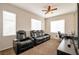 Living room with three black reclining chairs and a home office at 8152 Satin Carnation Ln, Las Vegas, NV 89166