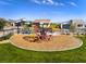 Community playground with modern play structure, surrounded by lawn and homes at 9927 Evergreen Pine St St, Las Vegas, NV 89166