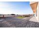 View of the backyard featuring desert landscaping with a small plot of grass and a low brick fence at 3690 S Spring Mountain Blvd, Pahrump, NV 89048