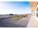 Expansive backyard with gravel, small trees, and a fire pit area, perfect for outdoor entertaining at 3690 S Spring Mountain Blvd, Pahrump, NV 89048