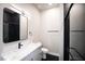 Contemporary bathroom featuring a black-tiled shower, marble counters, and modern finishes at 3690 S Spring Mountain Blvd, Pahrump, NV 89048