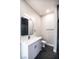 Modern bathroom featuring a vanity with marble counters, black hardware, and a black-tiled shower at 3690 S Spring Mountain Blvd, Pahrump, NV 89048