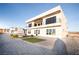 Modern two-story home featuring an outdoor balcony and desert landscaping in the backyard at 3690 S Spring Mountain Blvd, Pahrump, NV 89048