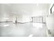 Bright, expansive garage with a sealed floor, multiple windows, and a roll-up door at 3690 S Spring Mountain Blvd, Pahrump, NV 89048