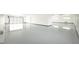 Huge garage featuring a sealed floor, windows for natural light, and a modern roll-up door at 3690 S Spring Mountain Blvd, Pahrump, NV 89048