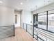 Upstairs hallway with modern railings and desert views at 3690 S Spring Mountain Blvd, Pahrump, NV 89048